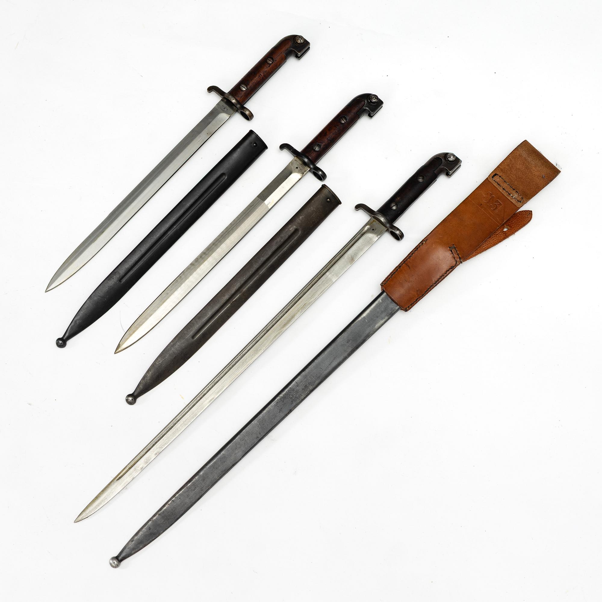 Three Swedish bayonets with scabbards.