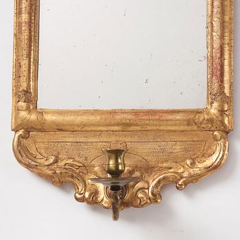 A matched pair of rococo giltwood one-light girandoles, later part of the 18th century.