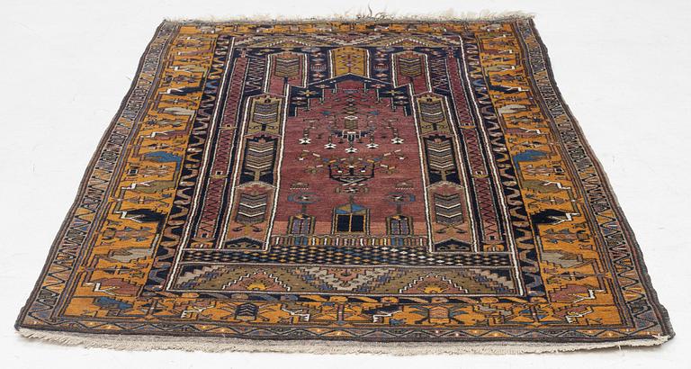 An Anatolian prayer rug, semi-antique, c. 205 x 115 cm.