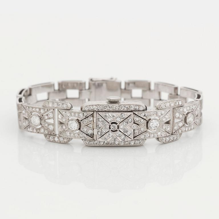 A bracelet/watch in platinum and 18K white gold set with old- and eight-cut diamonds.