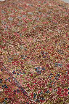 A CARPET, a semi-antique Kerman, ca 479 x 317 cm.