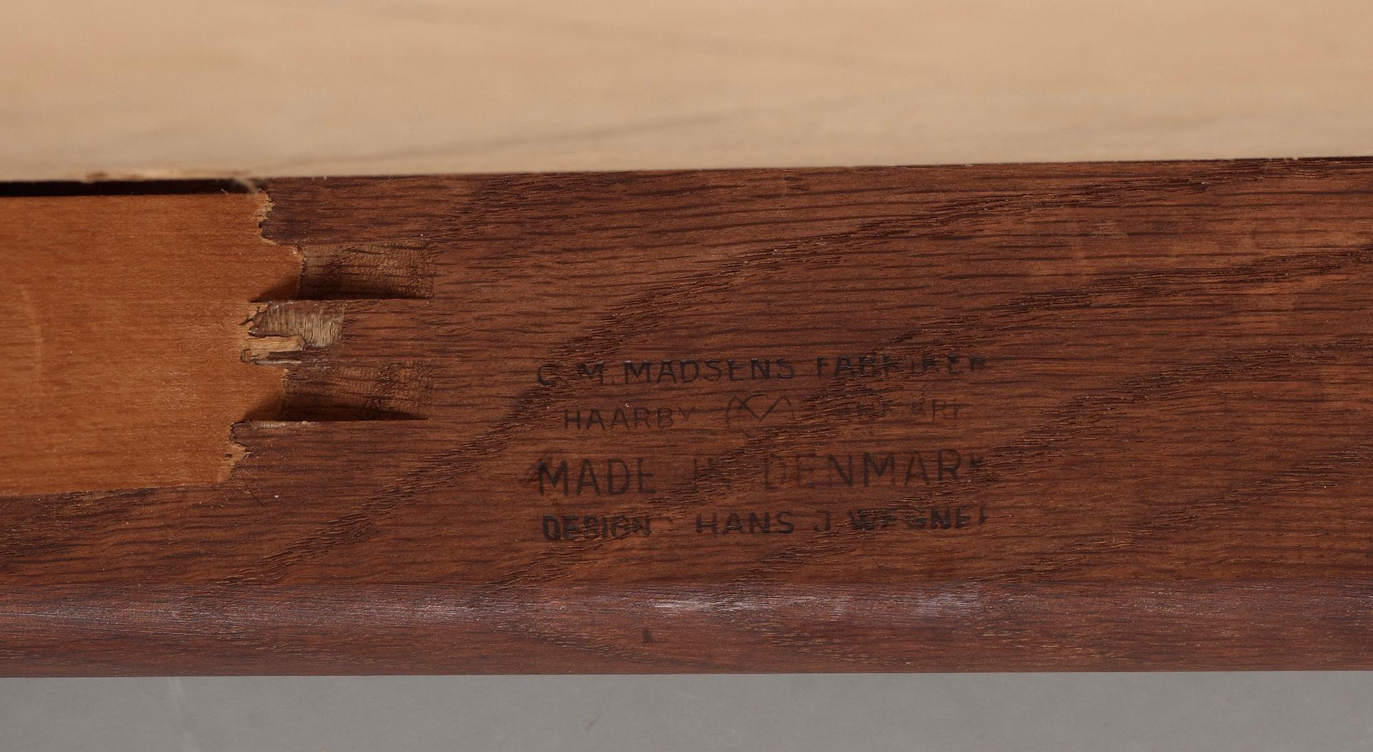 A Hans J Wegner oak dinner table 'AT 312' and four oak and black leather chairs, C M Madsen, Denmark 1950-60's.