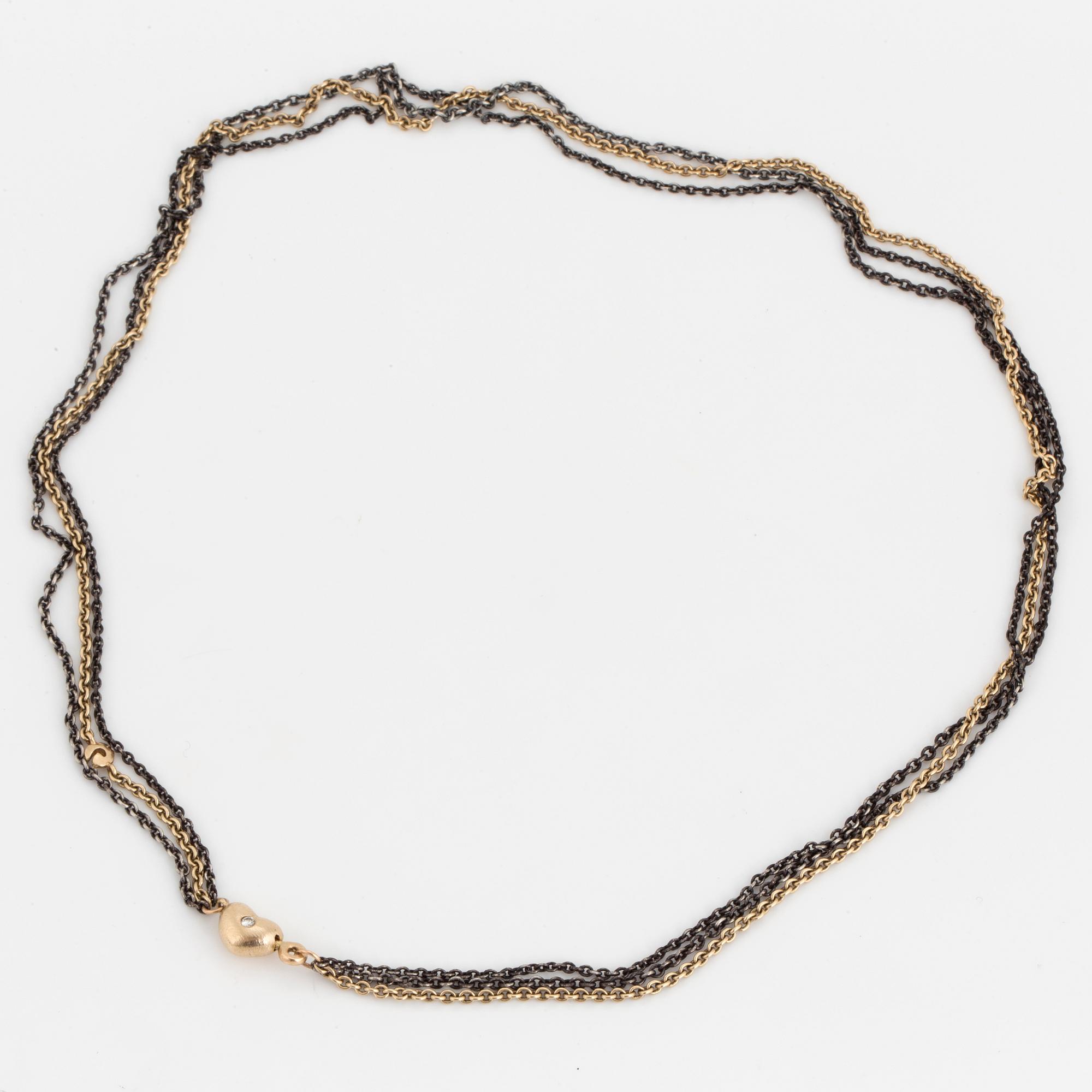 A necklace by Ole Lynggaard, the clasp decorated with a diamond.