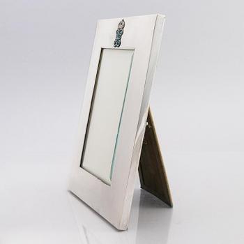 A silver and enamel frame with glass, mark of CG Hallberg, Stockholm 1937.