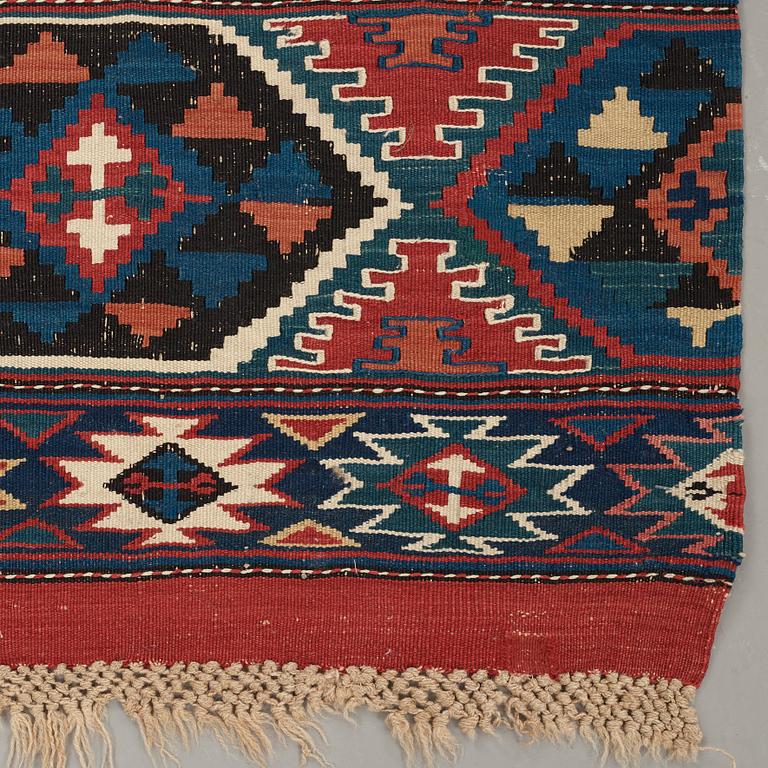 A CARPET, AN ANTIQUE AZERI KILIM, probably a Shirvan, ca 250 x 117,5 cm.