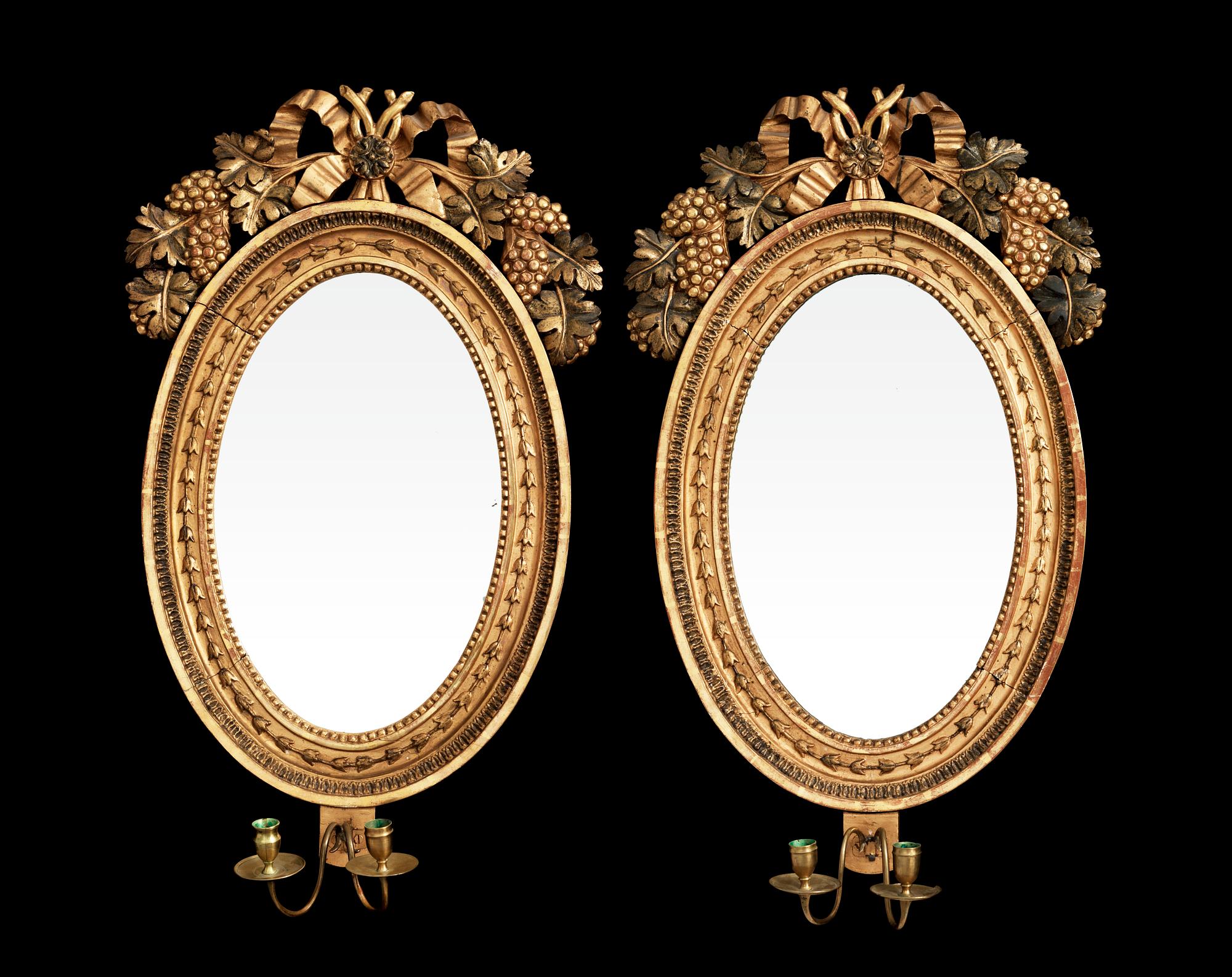 A pair of Swedish Empire early 19th century two-light girandole mirrors.