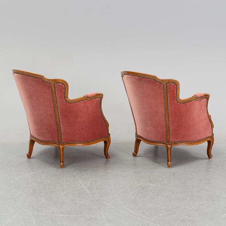 A pair of rococo style easy chairs from around the year 1900.