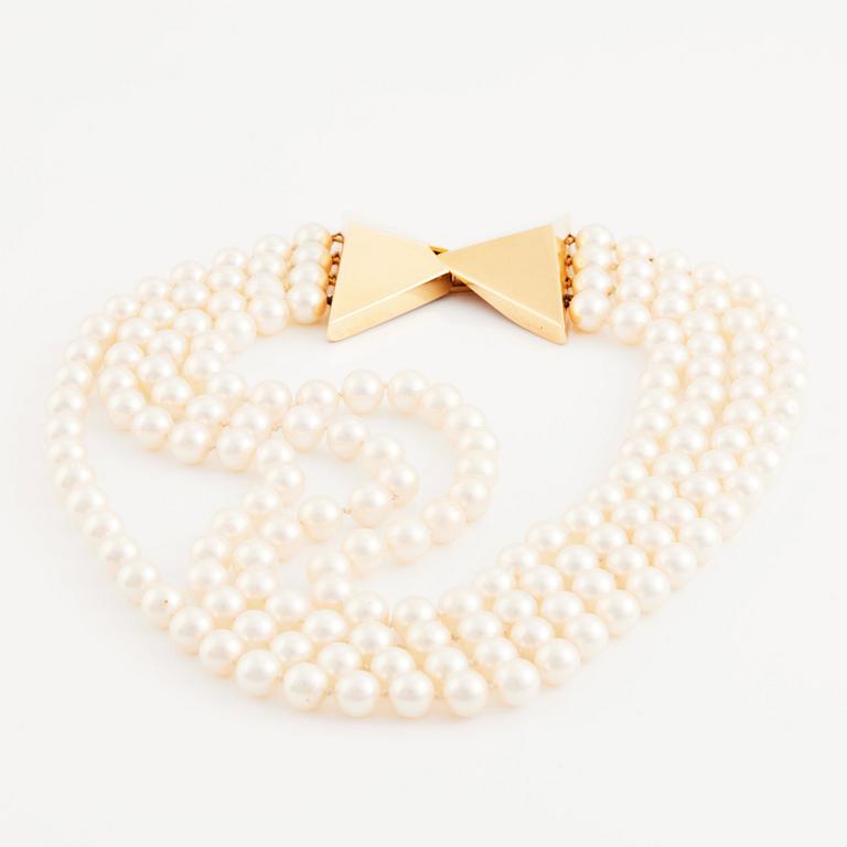 Kristian Nilsson, a four strand cultured pearl necklace with an 18K gold clasp, , Stockholm 1985.