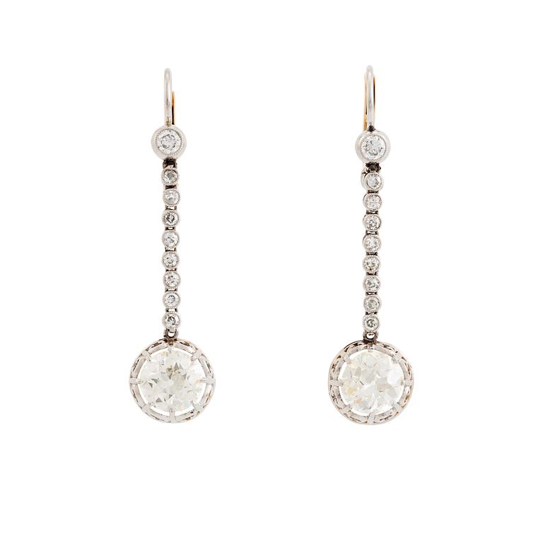 A pair of 18K white gold earrings set with old-cut diamonds.