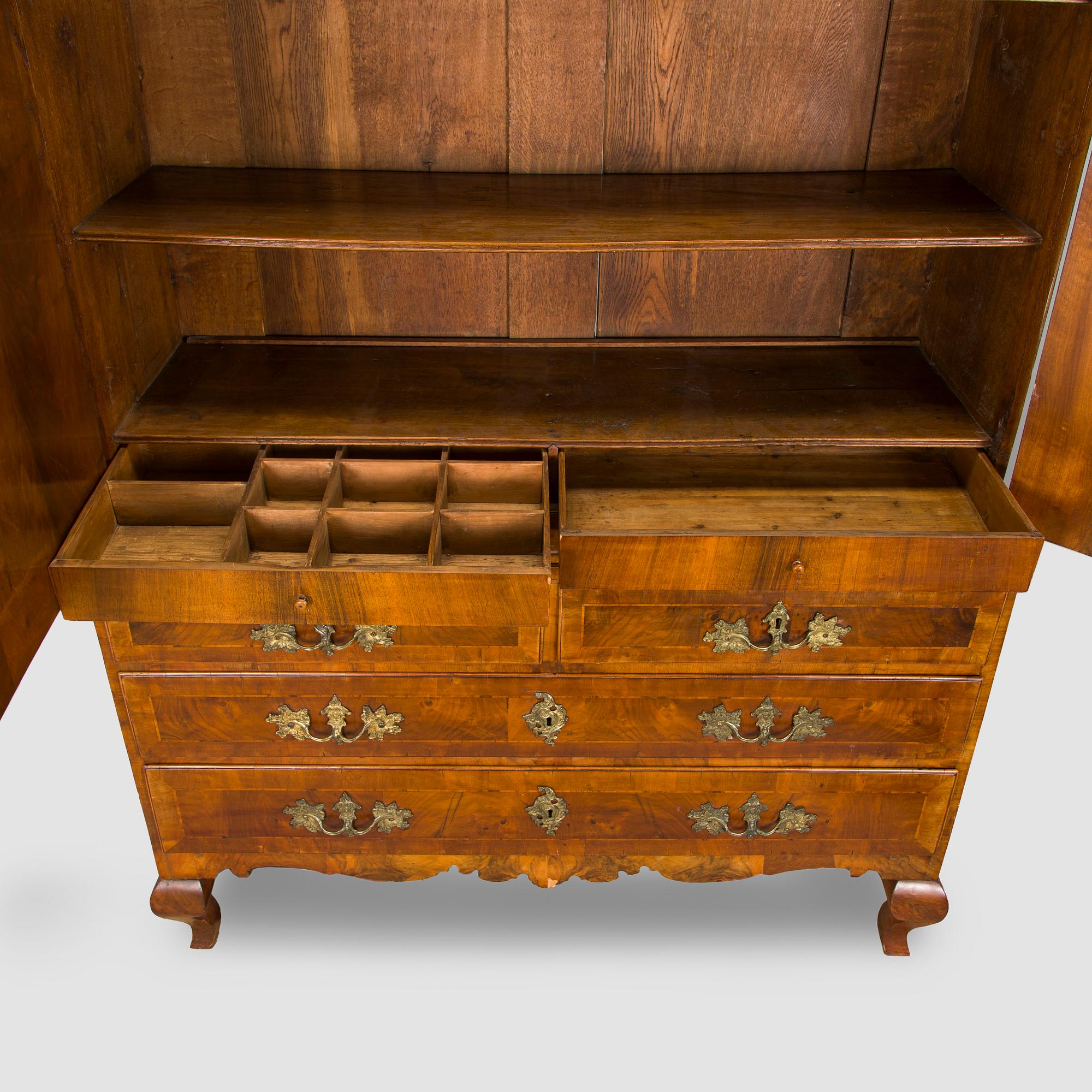 A Swedish walnut-veneered rococo cabinet in the manner of C. Linning, latter half of the 18th Century.