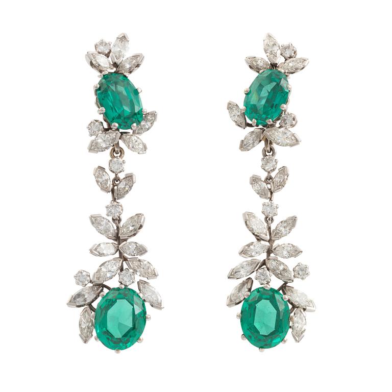 A pair of 18K white gold earrings set with round brilliant- and navette-cut diamonds and green synthetic stones.