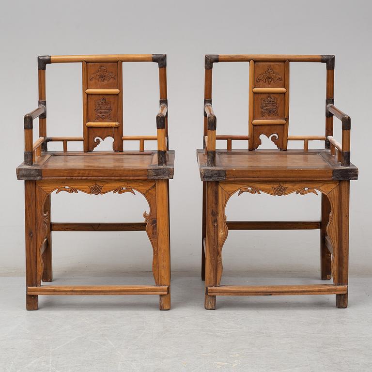 A pair of Chinese wooden armchairs, late 19th/early 20th century.