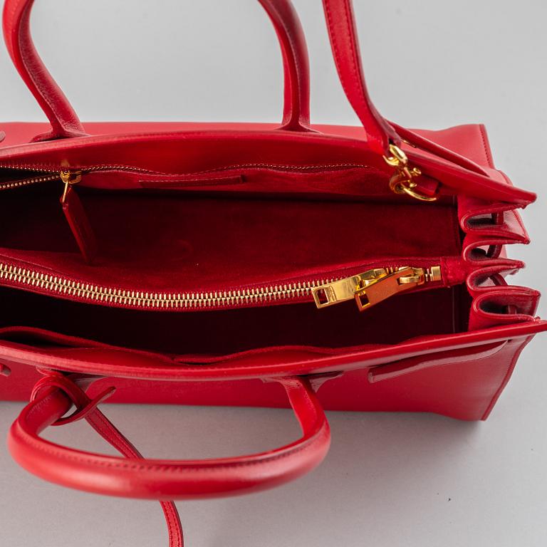 Saint Laurent, a red leather 'Sac du Jour Small' bag.