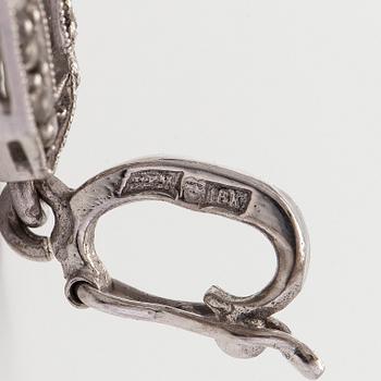 An 18K white gold pendant set with brilliant-cut and rose-cut diamonds.