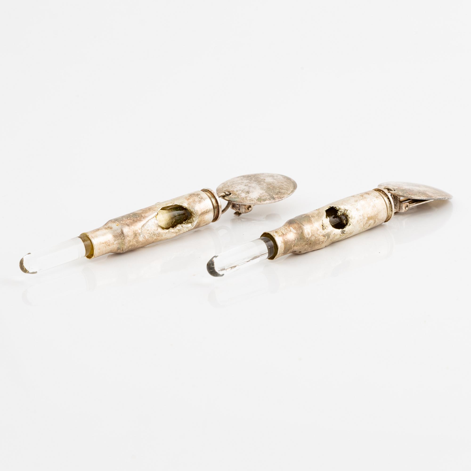 Earrings, possibly Slim Barrett.