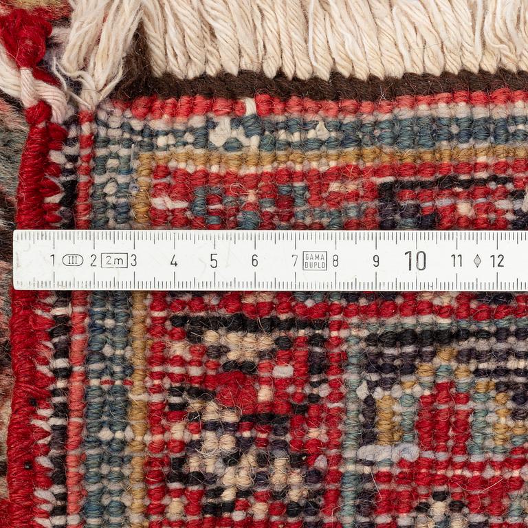 An old Heris carpet, c. 315 x 225 cm.