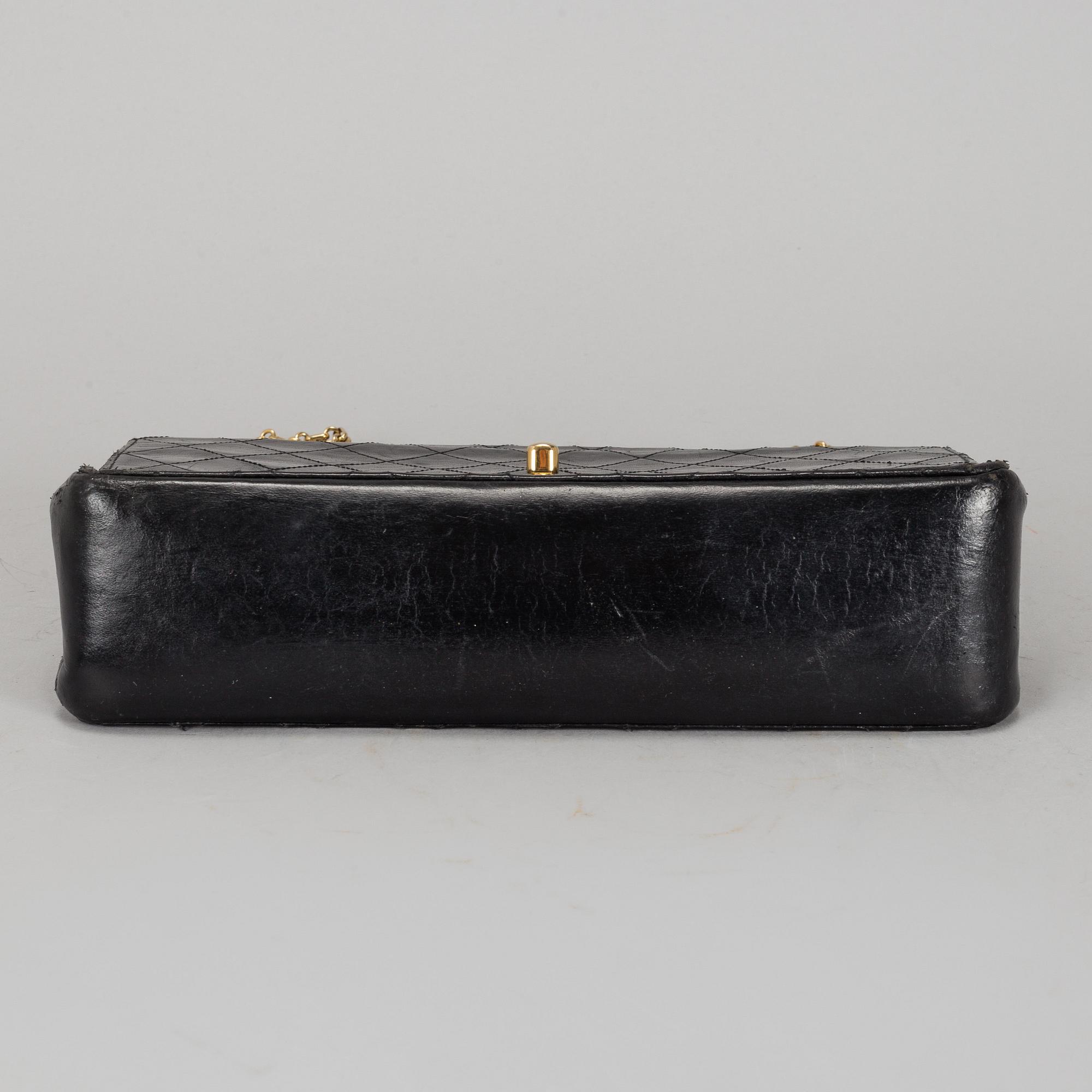 CHANEL, a quilted black leather 'Double Flap Bag'.