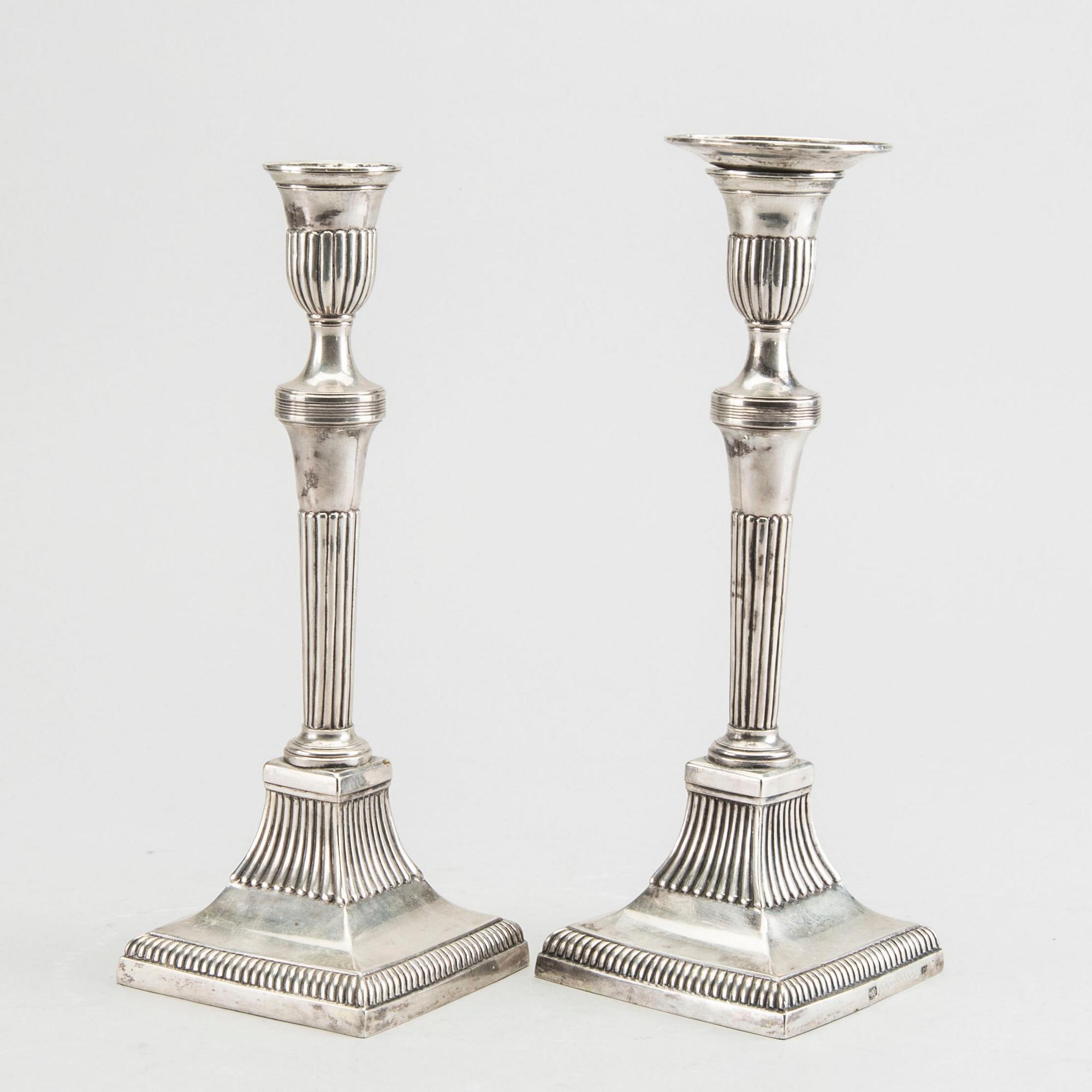 A pair of silver candle sticks around 1800 possibly Portugal, weight ca 734 gr, height ca 23 cm.