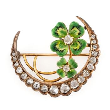 630B. A brooch in the form of a crescent moon in 14K gold  with enamel and rose-cut diamonds.