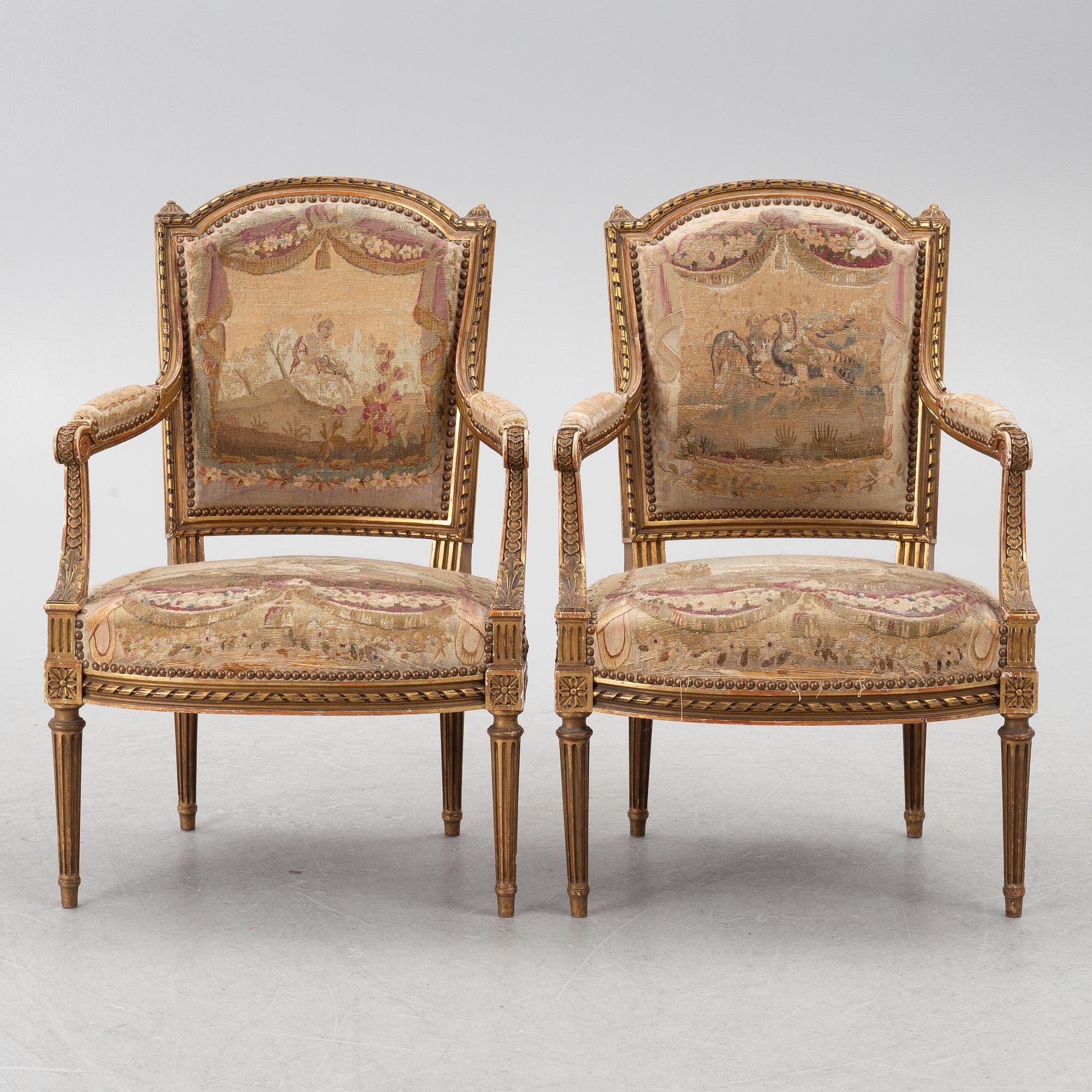A pair of Louis XVI-style armchairs, late 19th century with 18th century fabric.