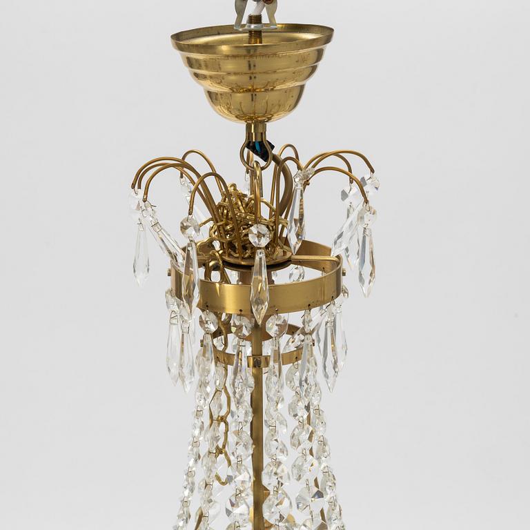 A contemporary matched pair of chandeliers for four candles each.