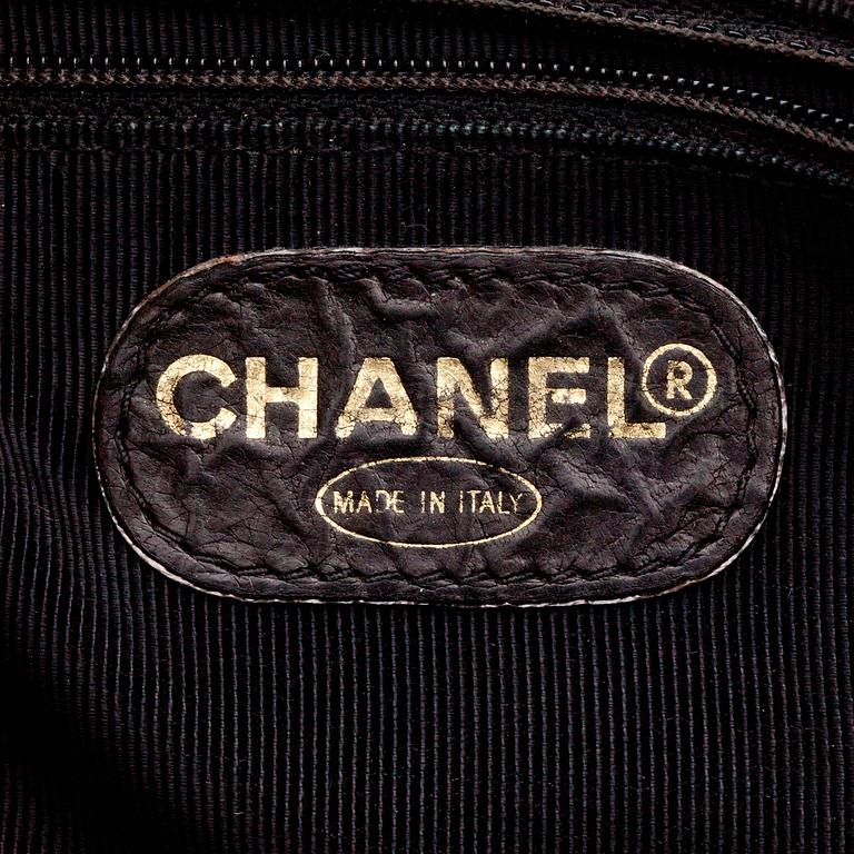 CHANEL, a quilted dark brown leather shoulder bag.