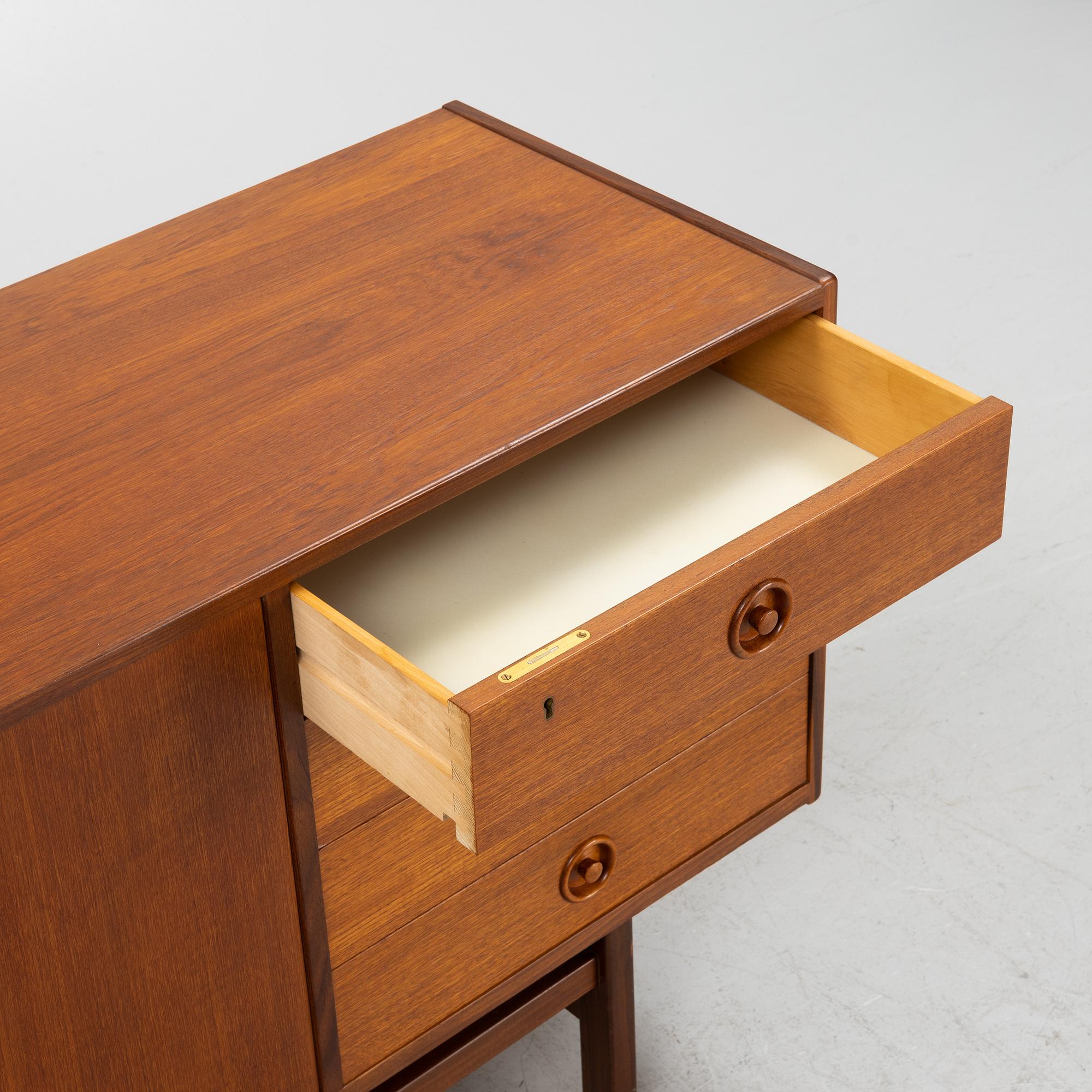 A 1960's teak-veneered sideboard.