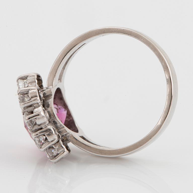 An 18K white gold ring set with a pink topaz and round brilliant-cut diamonds.