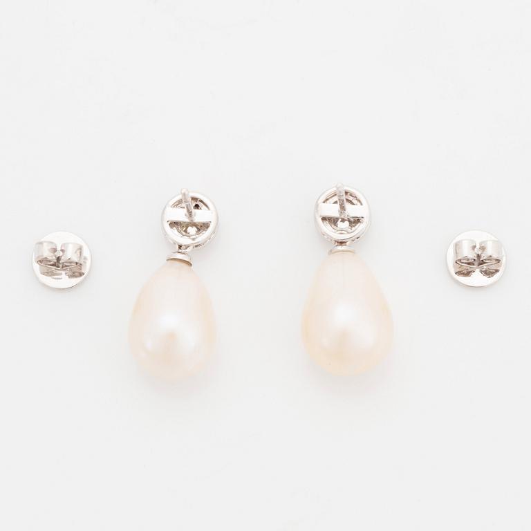 A pair of 18K white gold and cultured pearl earrings set with round brilliant-cut diamonds.