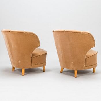 A pair of mid-20th-century armchairs.