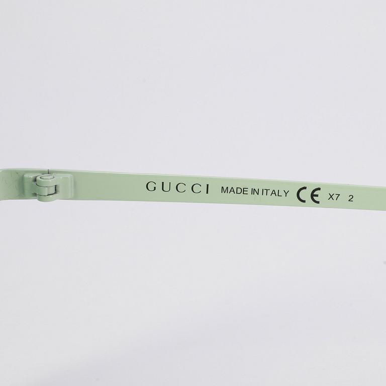 GUCCI, a pair of sunglasses.