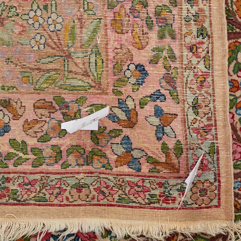 A CARPET, a semi-antique Kerman, ca 479 x 317 cm.