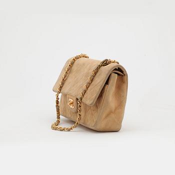 CHANEL, a beige suede quilted "double flap" shoulder bag.