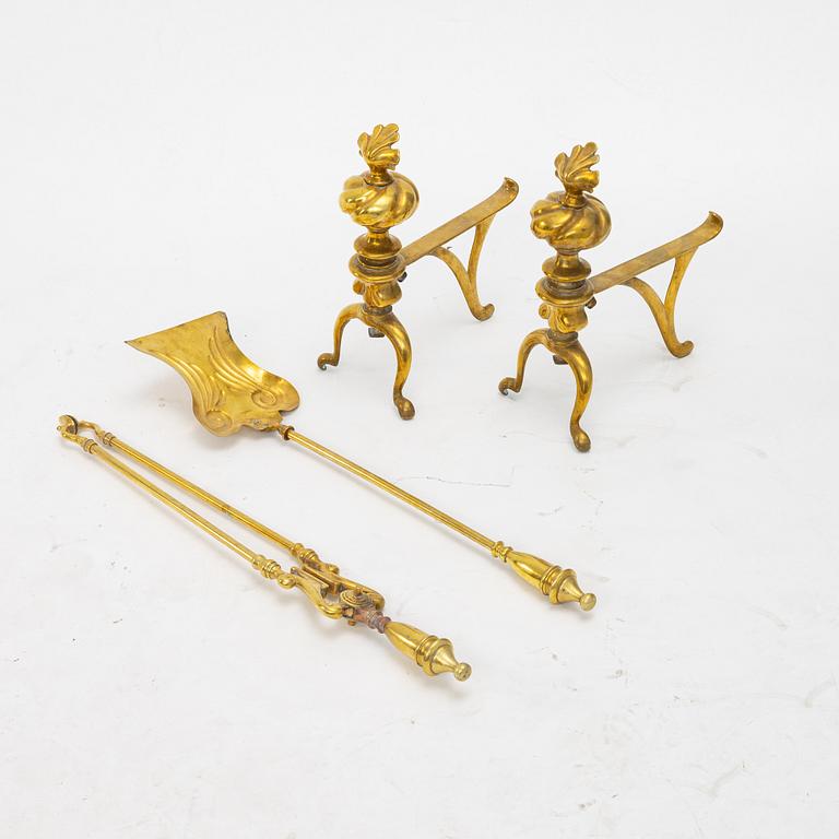 A four piece brass fire set, early 20th Century.