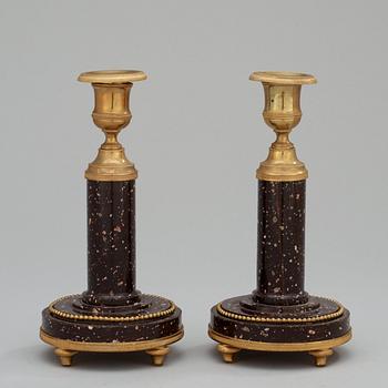 A pair of late Gustavian circa 1800 porphyry and gilt bronze candlesticks.