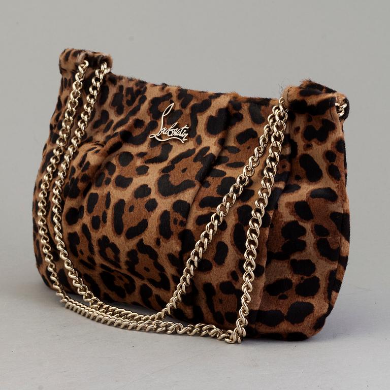 A leopard patterned ponyhair handbag by Christian Louboutin.