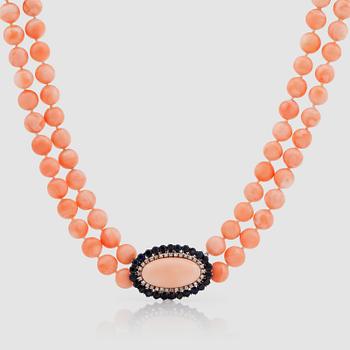 A coral necklace. Clasp with coral, sapphire and diamonds.