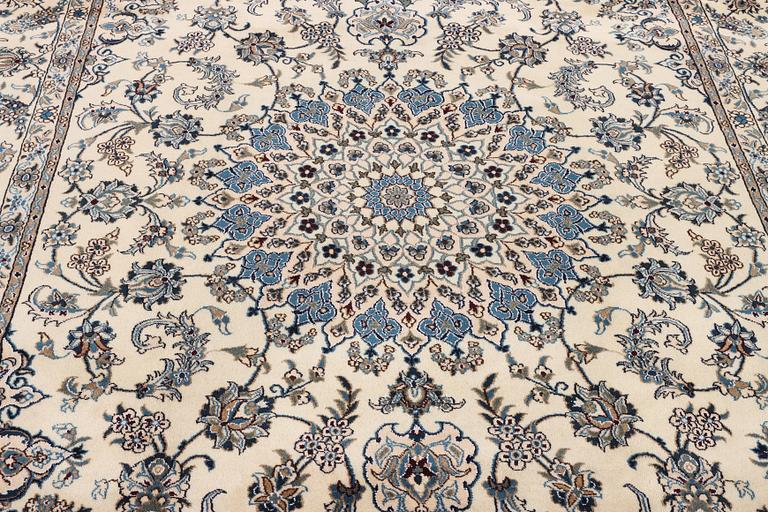A Nain, part silk carpet, c. 337 x 244 cm.