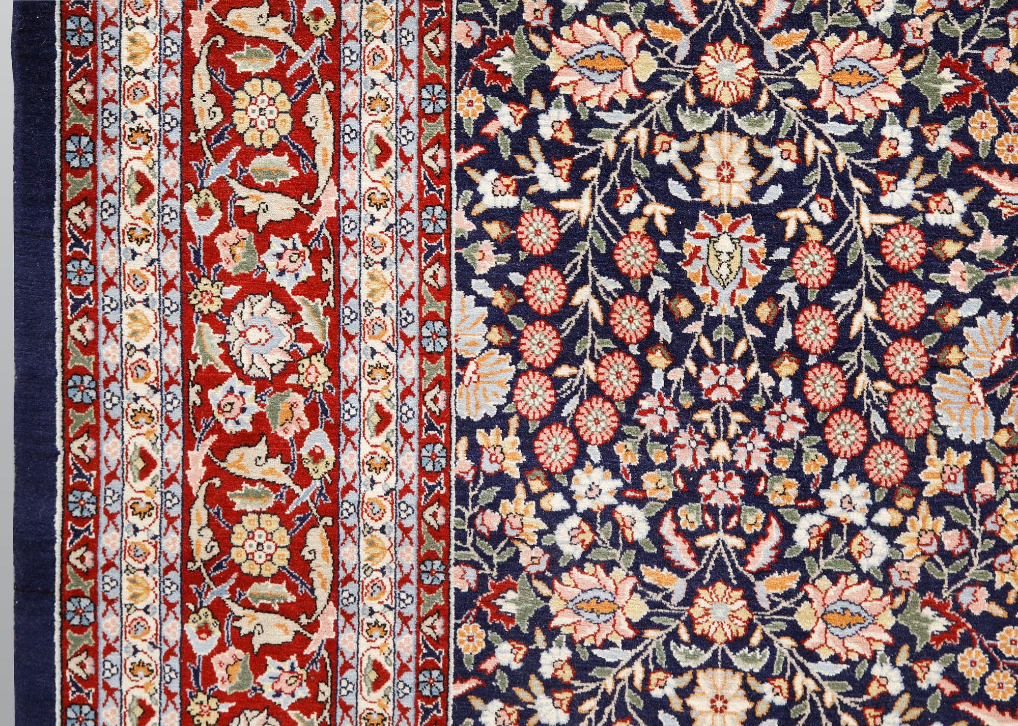 A signed Hereke carpet, ca 340 x 246 cm.