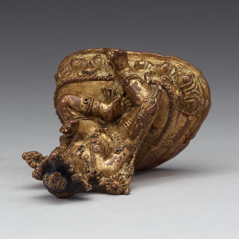 A Tibetan gilt copper alloy figure of Syamatara, 16th Century or earlier.