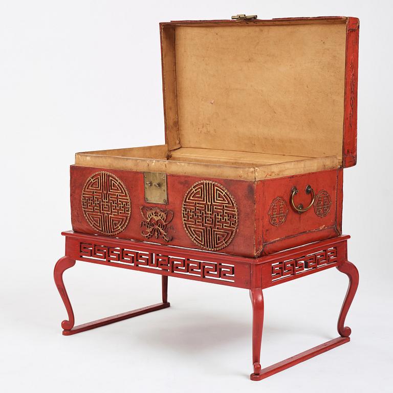 A red lacquered chest on a later stand, late Qing dynasty, 19th Century.