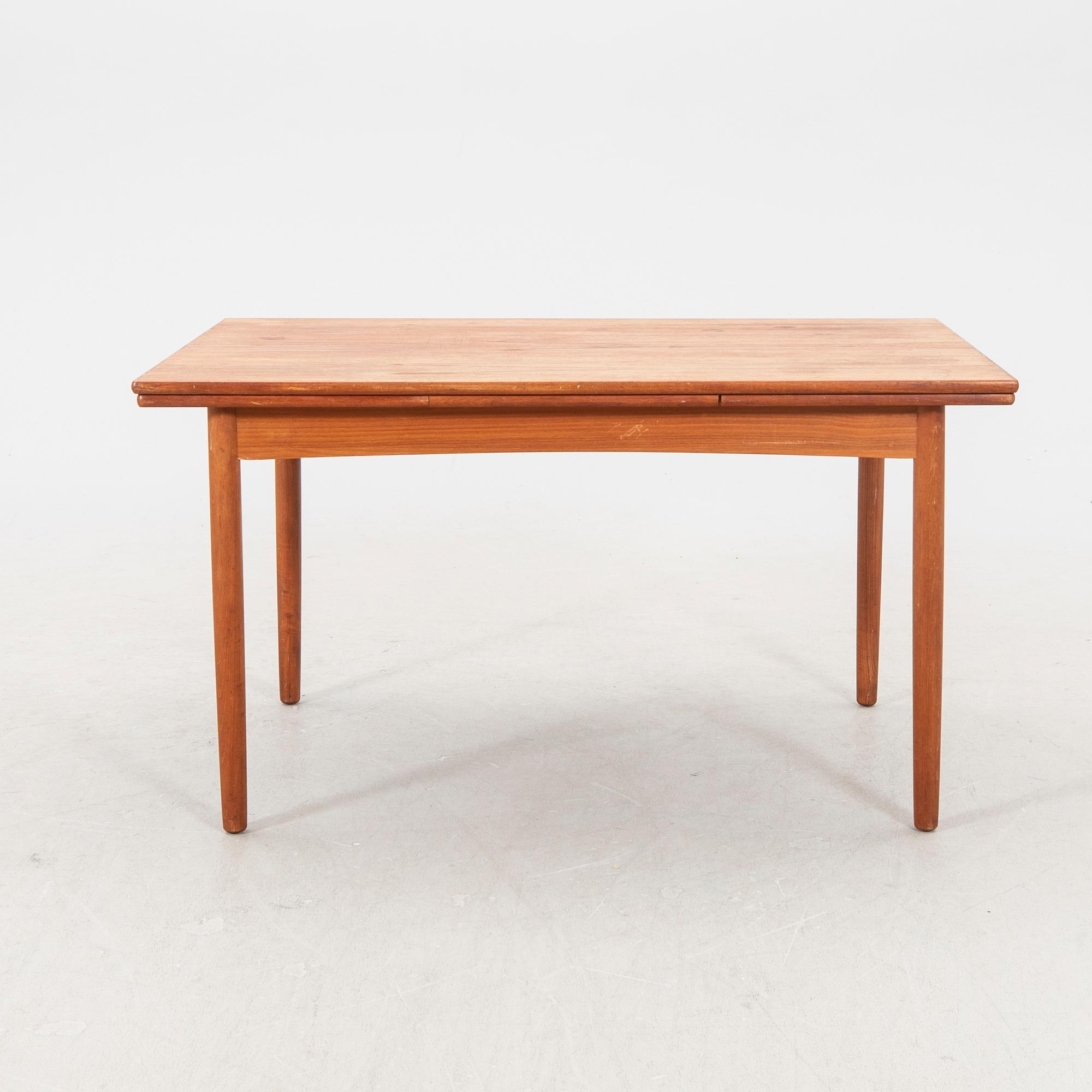 A 1960s teak dining table.