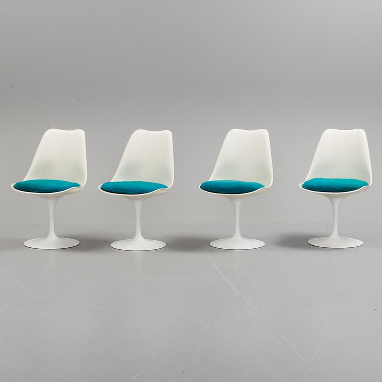 A "Tulip" table and four chairs by Eero Saarinen for Knoll International.