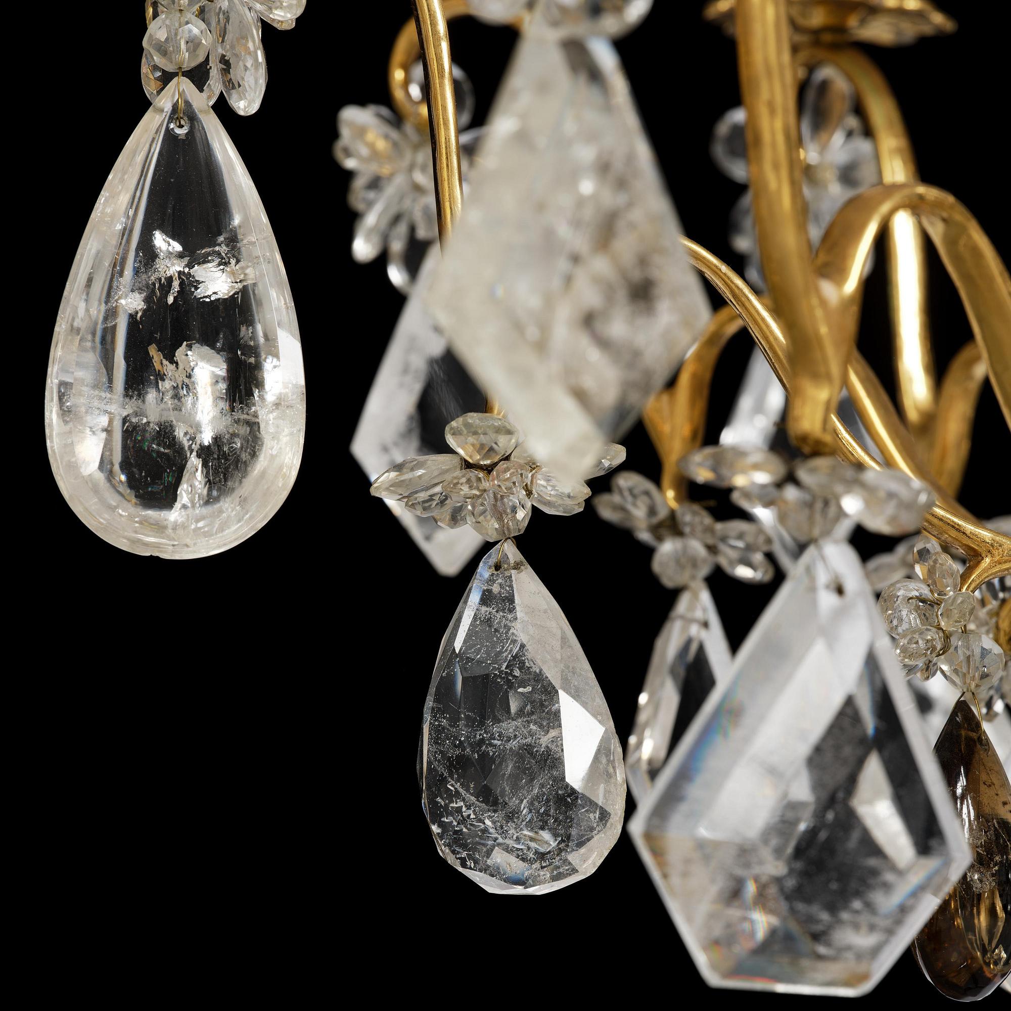 A near pair of Franch Louis-XV-style nine-branch gilt bronze and rock crystal chandeliers, later part 19th century.