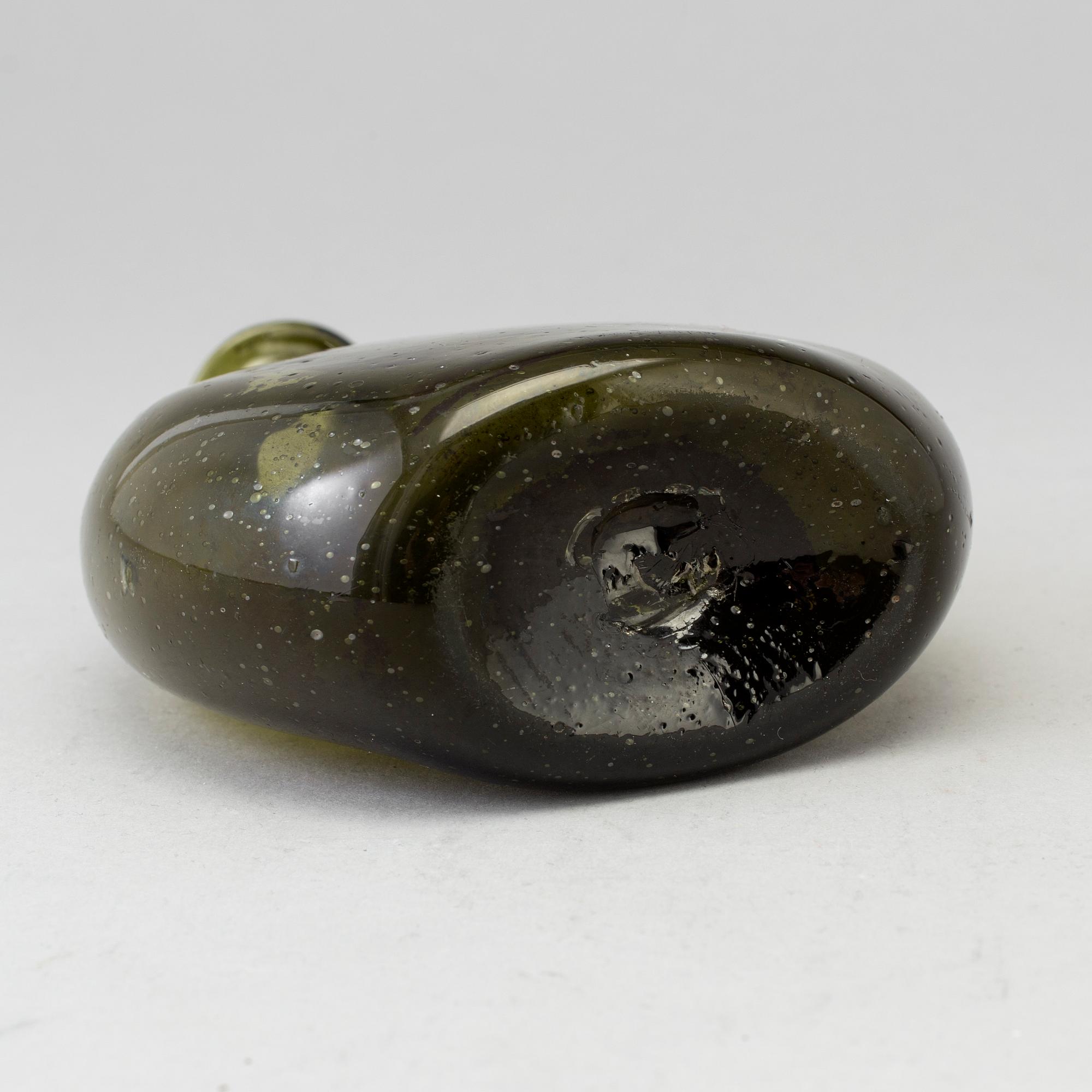 A 18th century glass bottle.