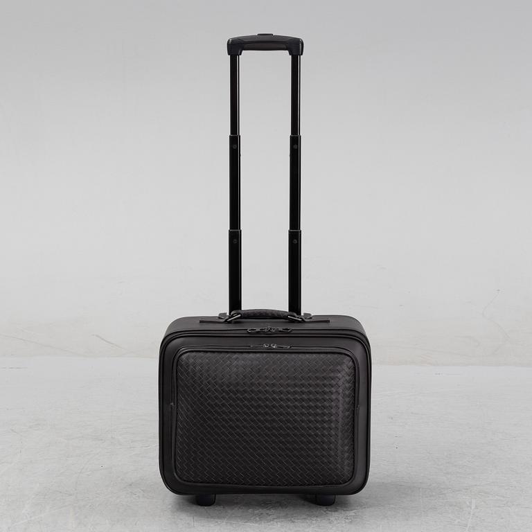 Bottega Veneta, an intrecciato leather suitcase.