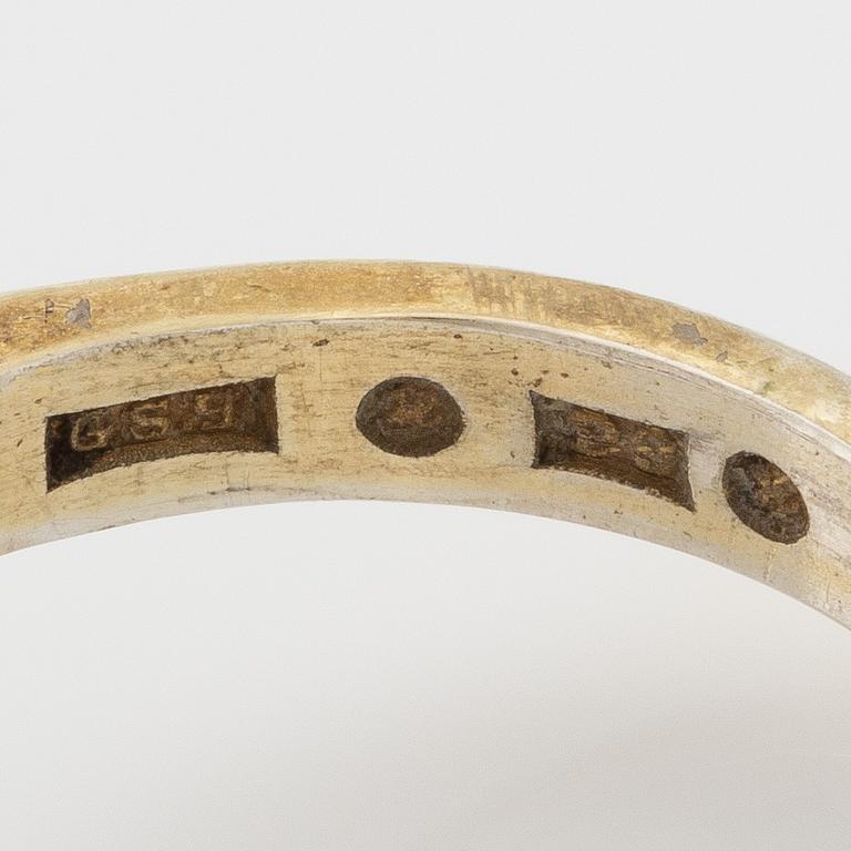 A set with a necklace, a bracelet, a brooch, and a ring.