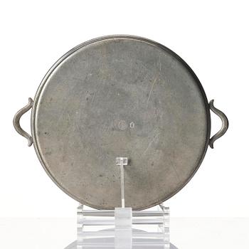 Firma Svenskt Tenn, a set of two pewter trays, Stockholm, 1930 and 1927.