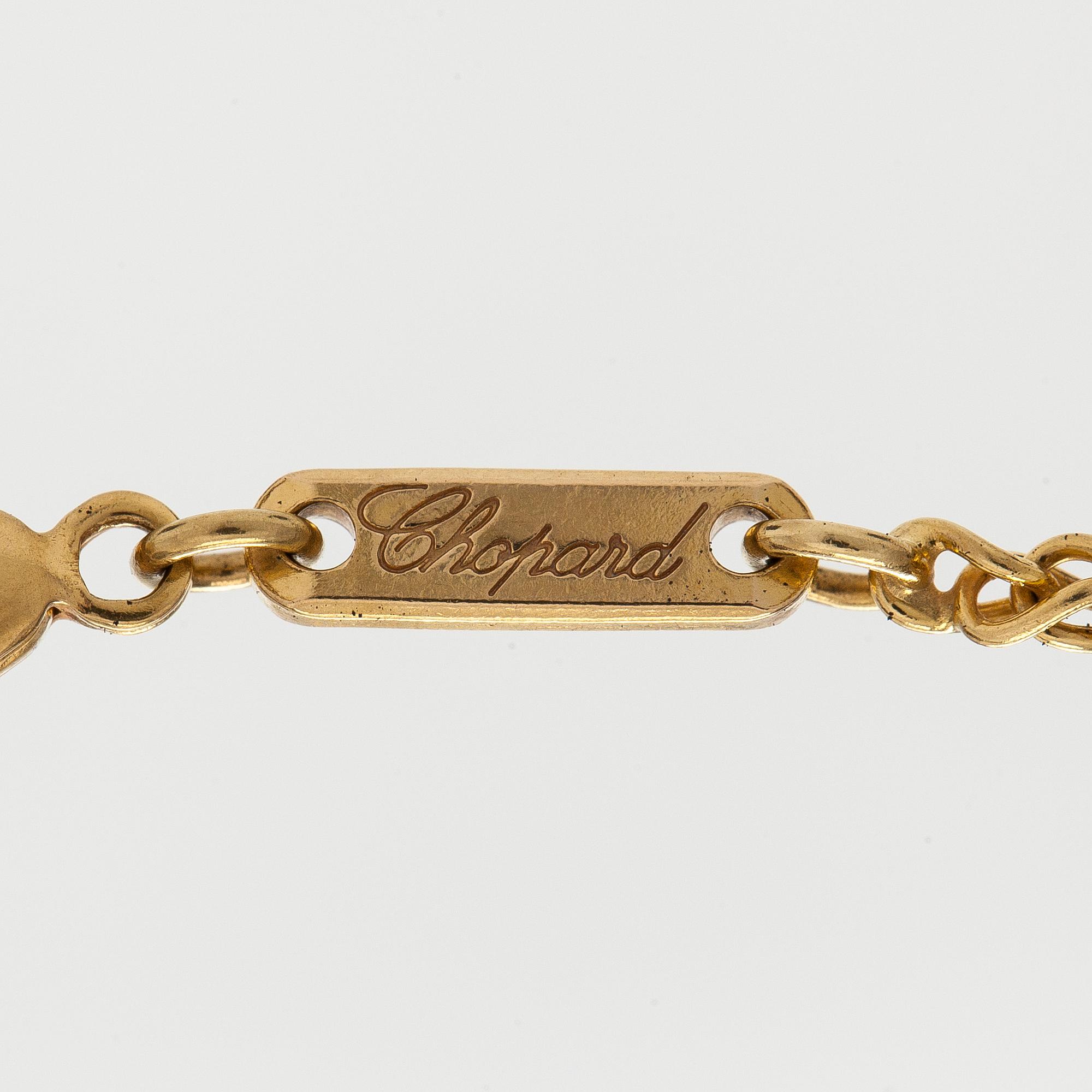 Chopard, an 18K gold 'Happy Diamonds' necklace with brilliant-cut diamonds.