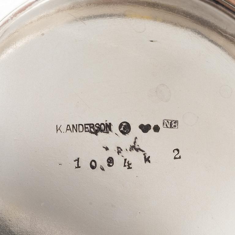 Three Silver Shakers and a Beaker.